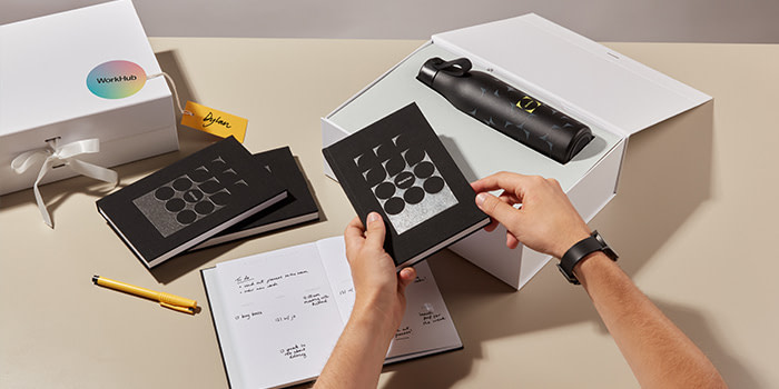 A gift box containing a branded Water Bottle and Notepad from business