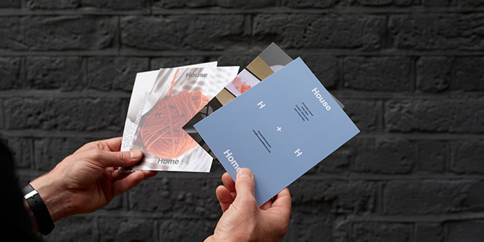 Person holding a few different Modern Postcards.