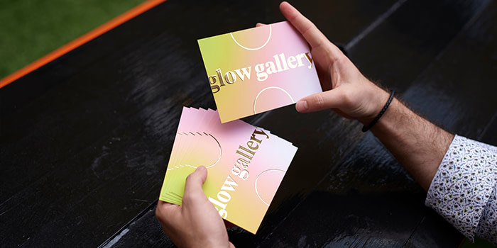 Person holding a few Postcards with Gold Special Finish across the front.