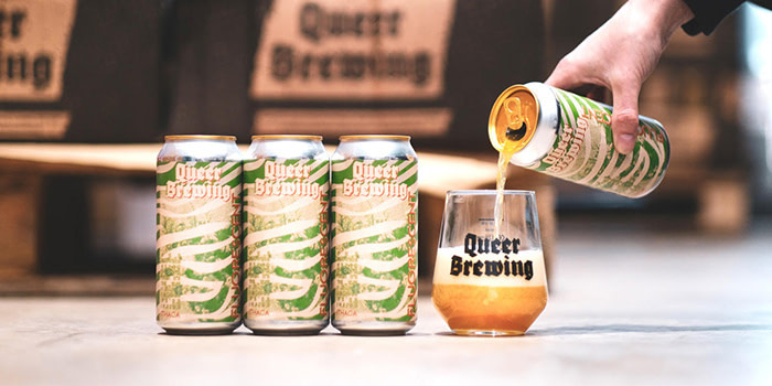 Queer Brewing beer being poured into a branded glad