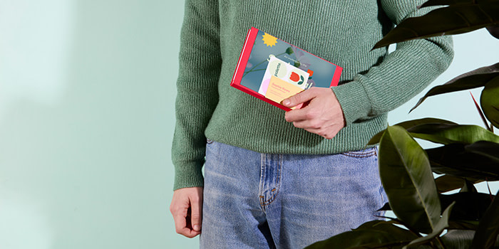 A event attendee holding a set of printed gifts from a trade show