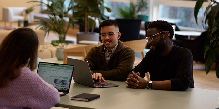 A group of MOOsters sitting together and working on a new client brief