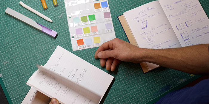 A person flipping through a journal.