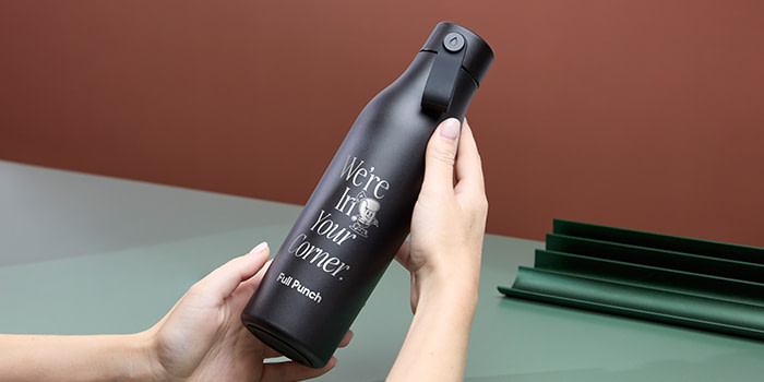 Engraved Water Bottle being held by employee.