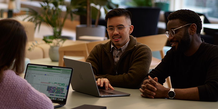 Employees having an in person meeting at work.
