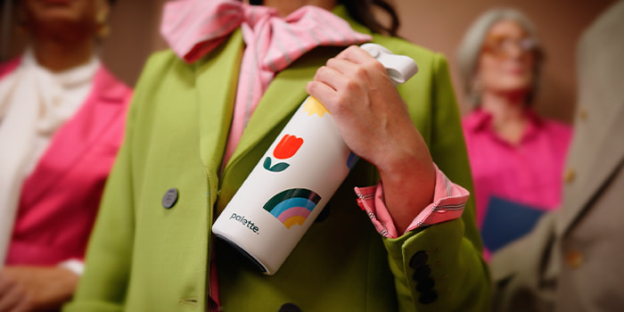 Person holding MOO Water Bottle.