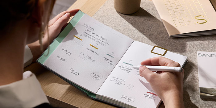 Person writing on notebook.