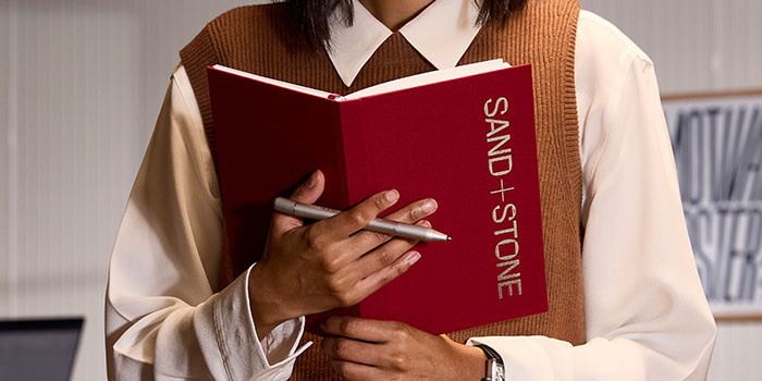 Person holding onto Notebook.