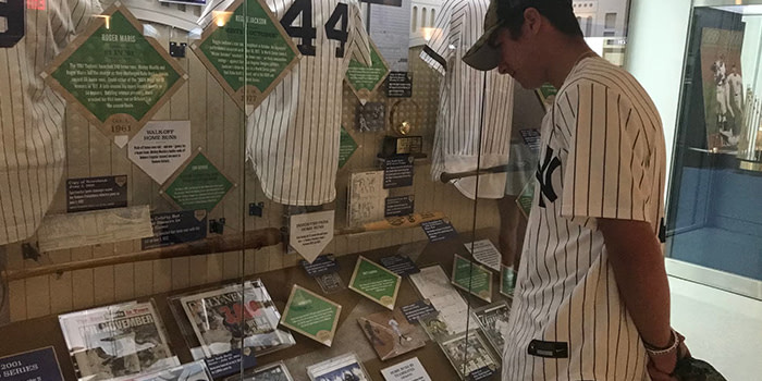 A sports fan looking at sports memoribilia on display.