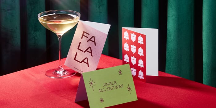 Greeting cards on table with drink.