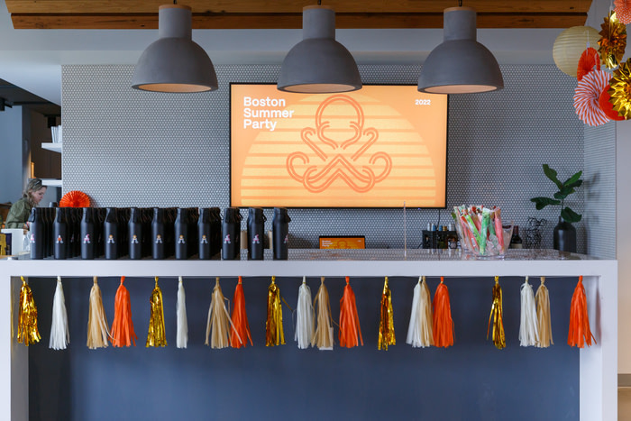 Summer office party setup with balloons and goodies and customized water bottles for employees to take