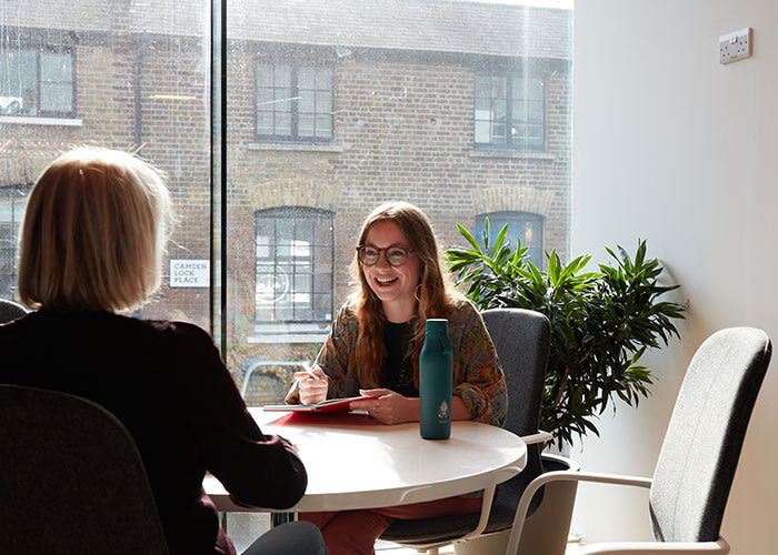 Two people in a meeting room in the MOO office