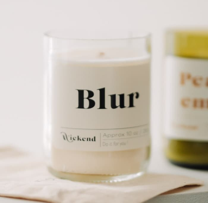 2 Wickend candles with rectangular product labels made with MOO