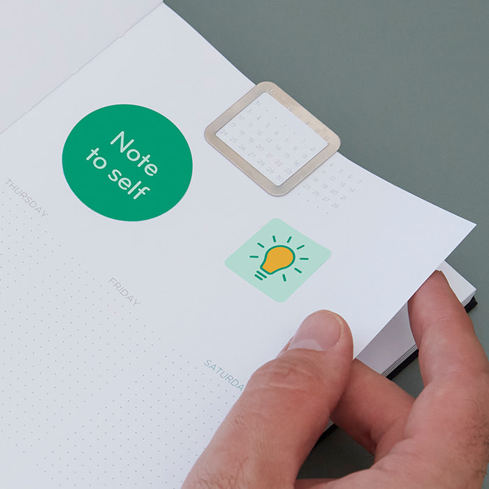 Custom Stickers and Calendar Clip inside a work planner.