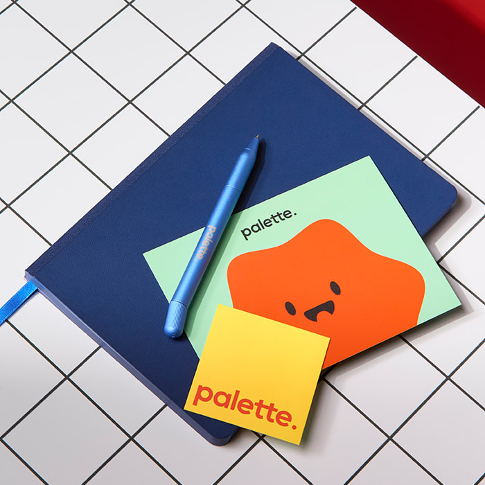 Notebook, Twist Pen, Brochure and Business Card on a desk.