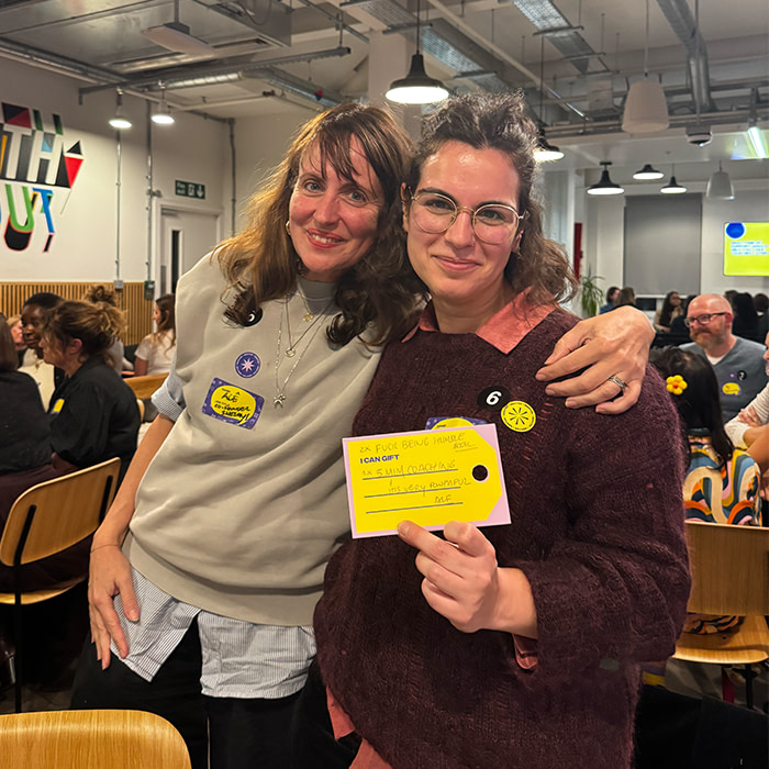 Women at event holding MOO print.