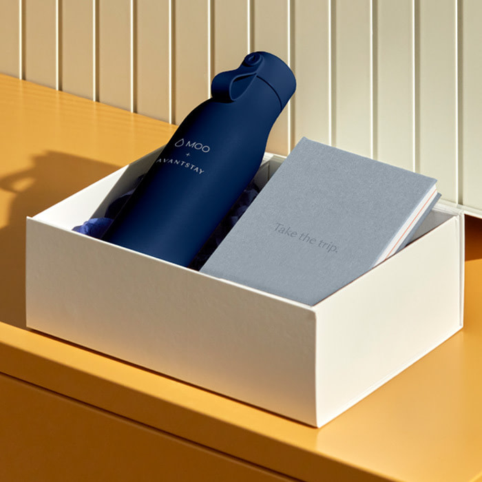 A branded Water Bottle and Notebook placed in a box.