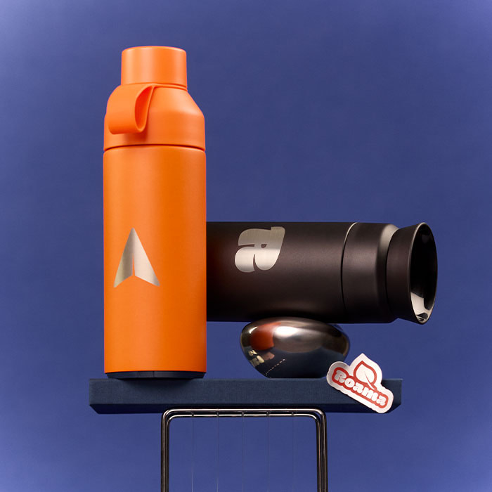 A branded orange Water Bottle and branded black Water Bottle on display with a dark blue backdrop.