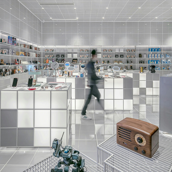 Someone walking through a a pop up at a tech store.