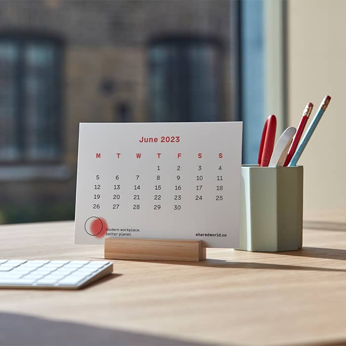 Postcard product used to create a calendar product on a desk in an office 