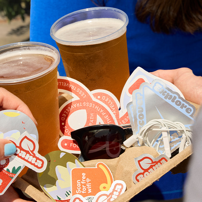 Beer in cup holders with branded Stickers.