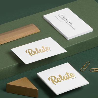 Relate gold foil business cards on green background