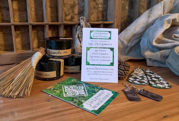 Green business cards front and back for curiosity cabinet shop Rerooted merchantile