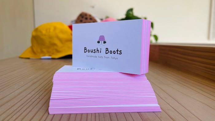 Pile of premium thick business cards with a pink edge by Boushi Boots
