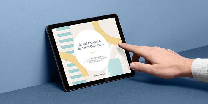hand touching a tablet to open a digital marketing ebook