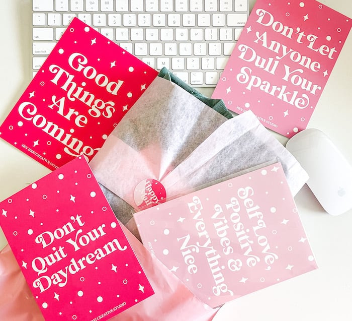 Keyboard, mouse, packaging and 4 pink postcards with positive affirmations and motivational quotes by Hey Bre Creative Studio