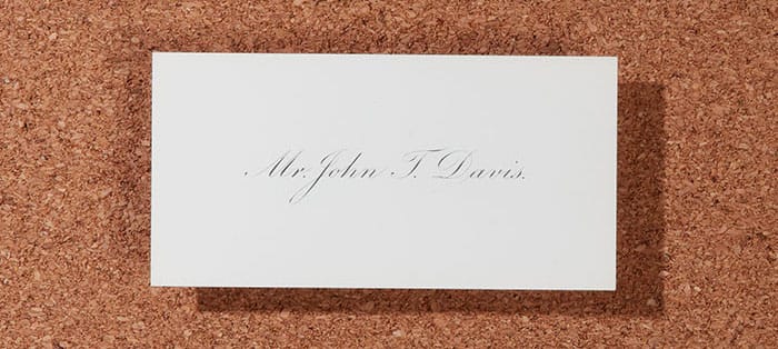 Mr John Davis vintage business card on a cork board