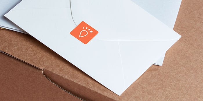 White envelope with an orange sticker with the GRR logo