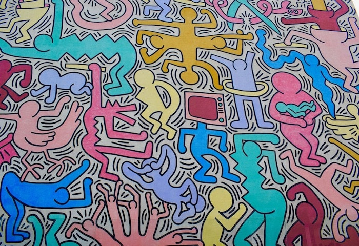 Colorful mural with various characters by Keith Haring