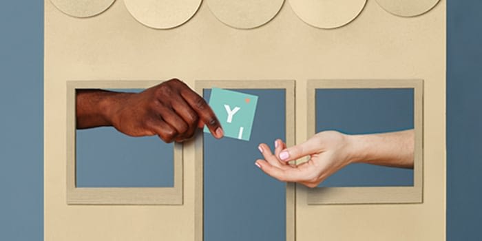 hands exchanging a square business card