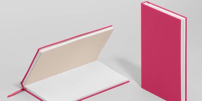 MOO hardcover notebook in new pink punch color, shown both open with lined paper and closed