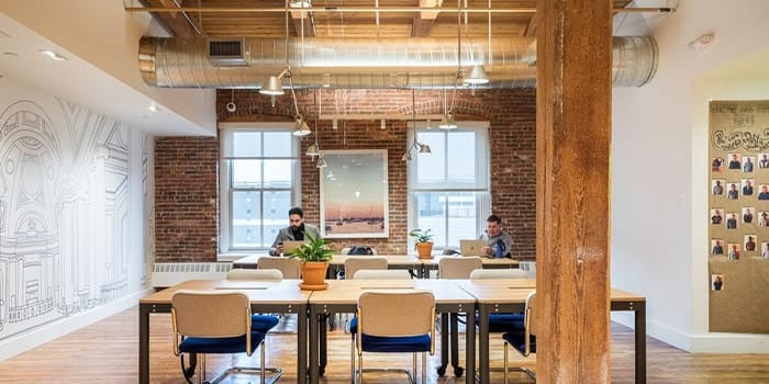 People working in a WeWork office space