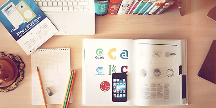 Logo ideas in a book, phone and laptop