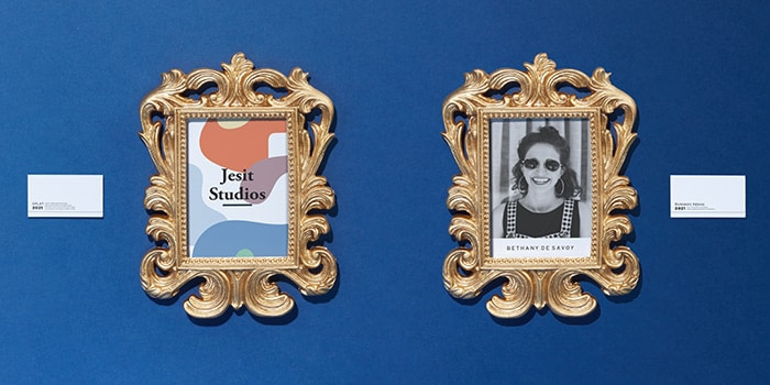 Outdated business cards displayed in gold baroque frames like artworks in a museum