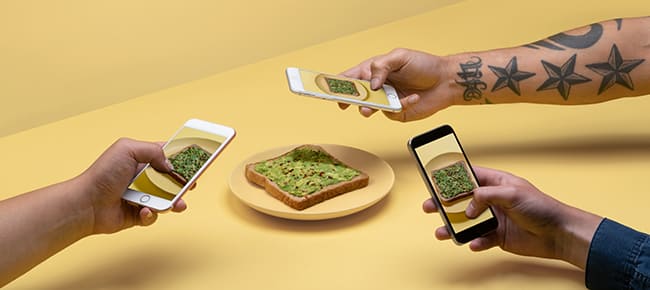 people taking picture of an avocado toast