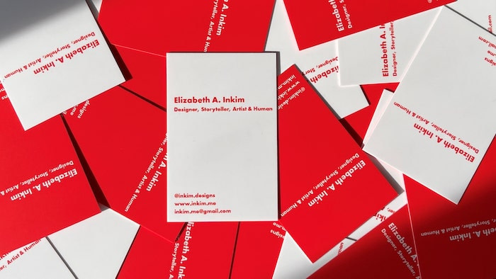 Elizabeth Inkim's designer business cards with a white front and a red back