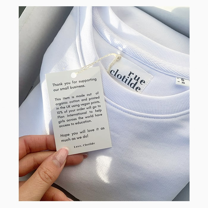 Rue Clotilde white tshirt with hang tag explaining the sustainable production process