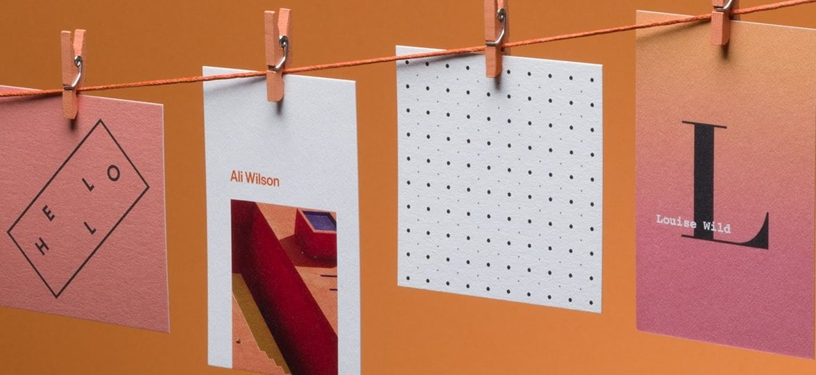 4 recycled cotton business cards in different sizes and designs hanging on a washing line