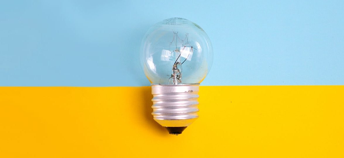 Light bulb on a yellow and blue background