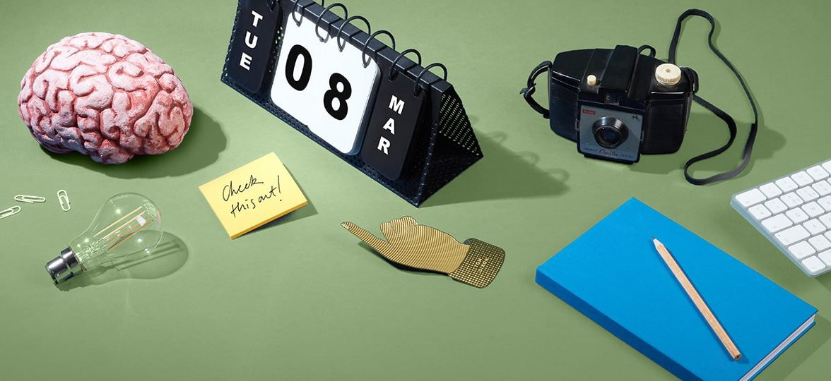 Brain, perpetual calendar and other accessories on a green table