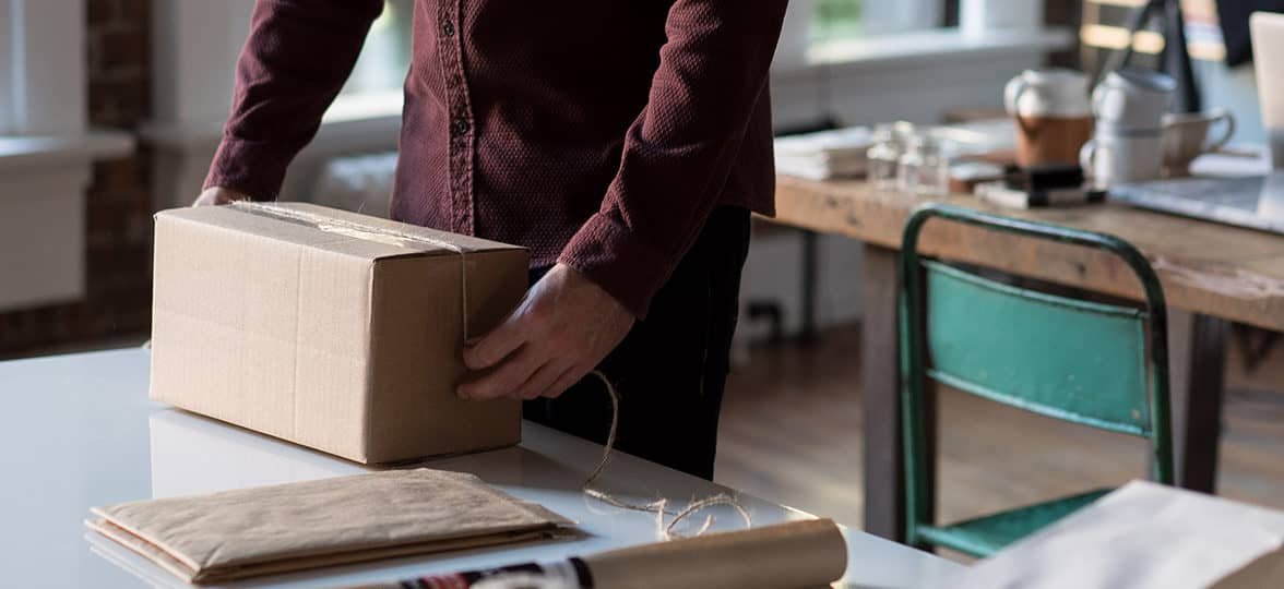 Person preparing parcels to send in a studio