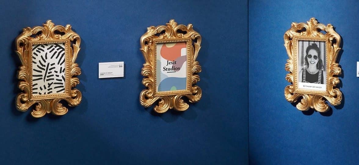 Outdated business cards displayed in gold baroque frames like artworks in a museum