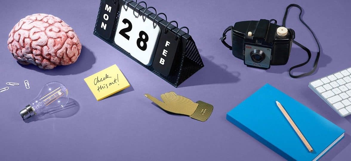 Brain, perpetual calendar and other accessories on a purple table