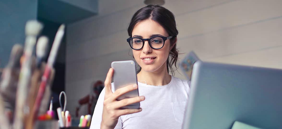 person checking phone at desk