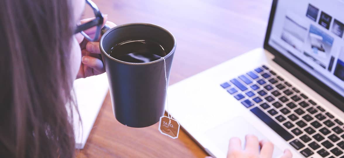 person working and drinking tea