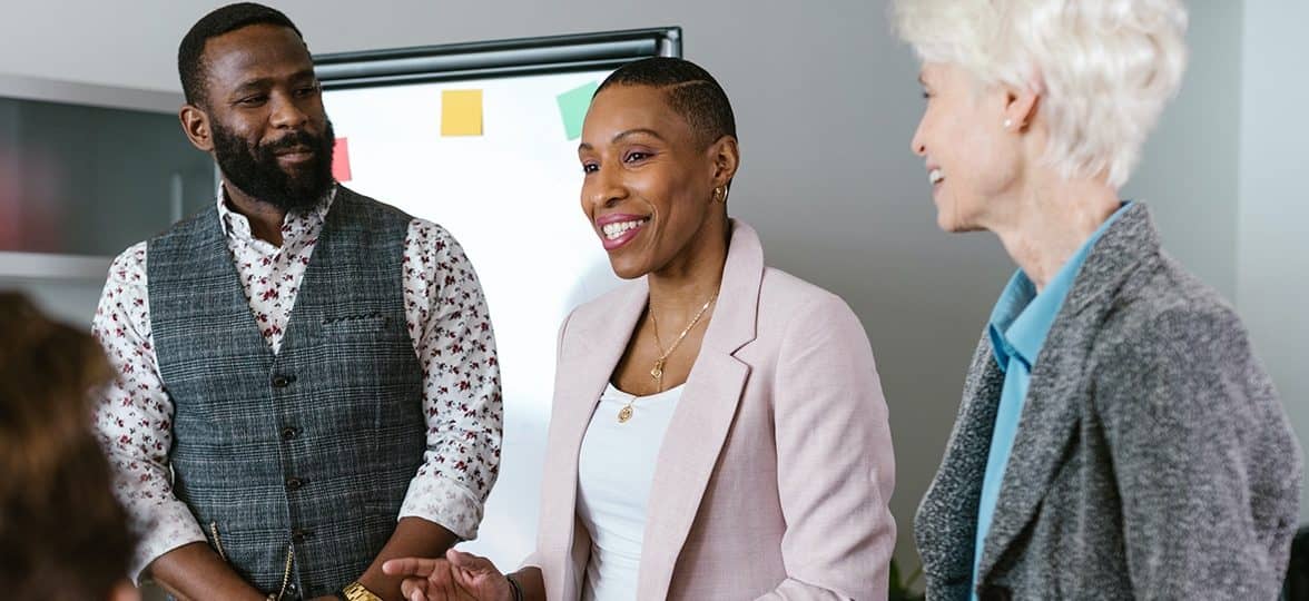 three people pitching an idea in a meeting